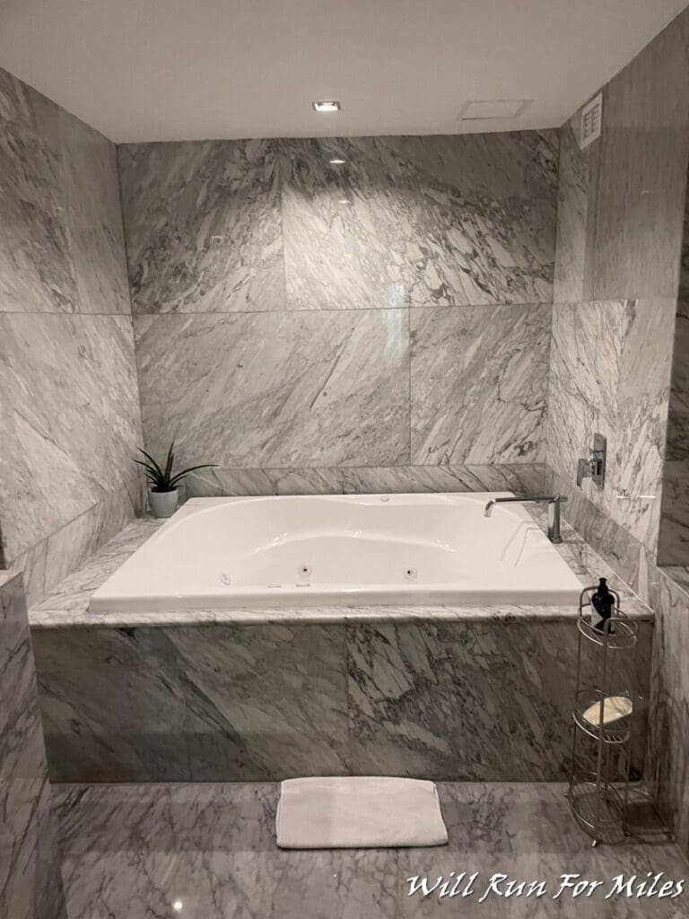 a bathroom with a tub and toilet