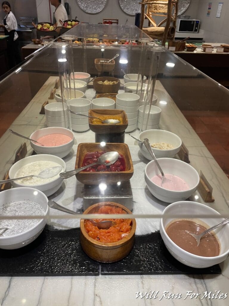 a buffet table with bowls of food