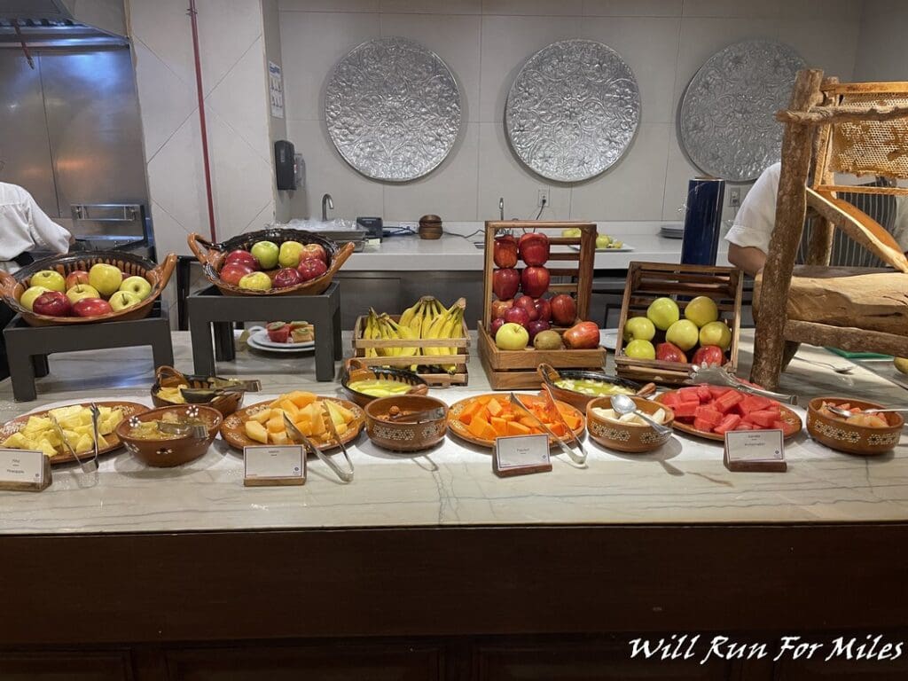 a counter with fruit in baskets