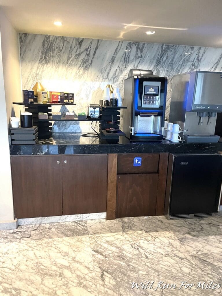 a coffee machine and a refrigerator in a room