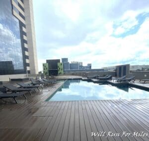 a pool with lounge chairs on a deck