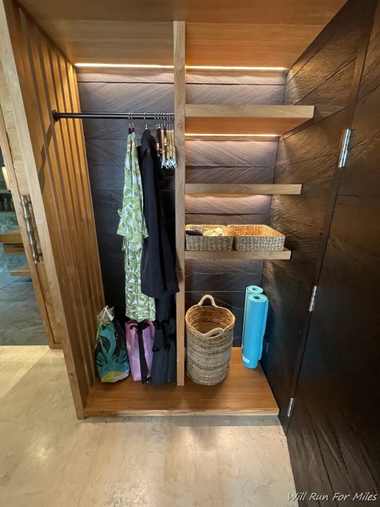 a closet with shelves and clothes