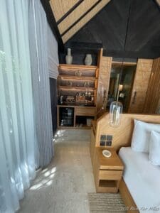 a room with a bed and shelves