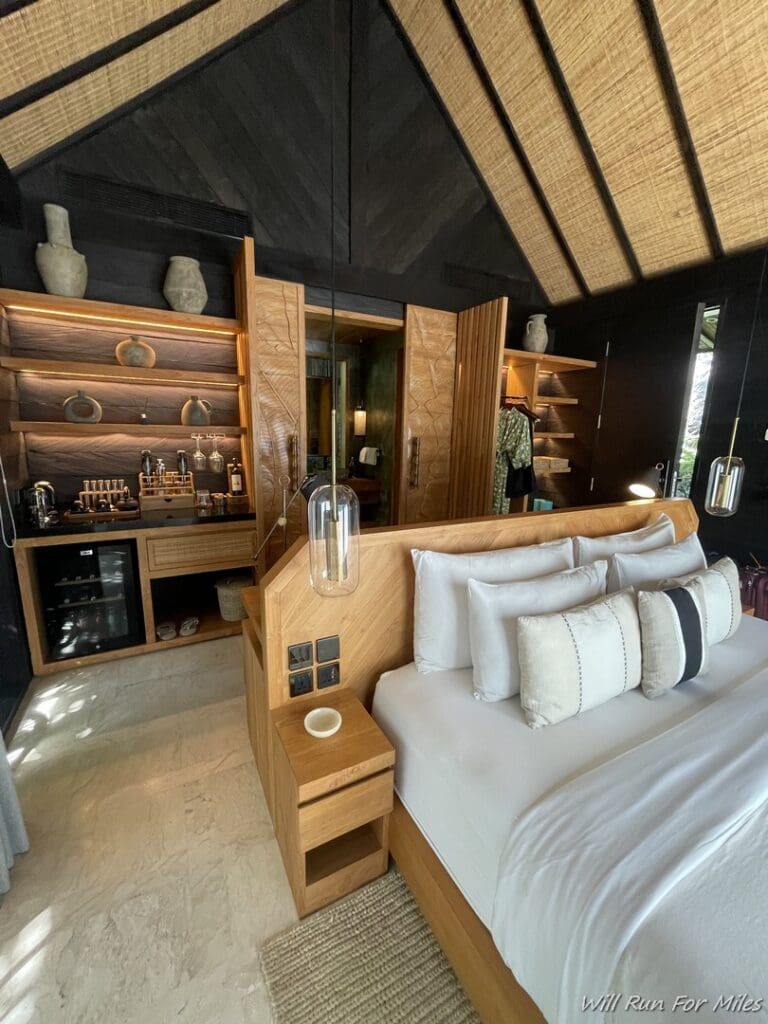 a room with a bed and shelves