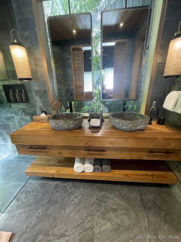 a bathroom with a double sink and a mirror