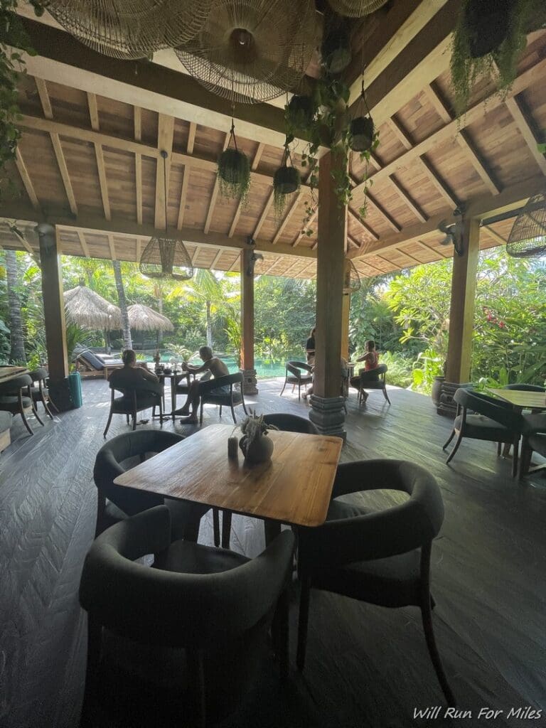 a wooden patio with tables and chairs