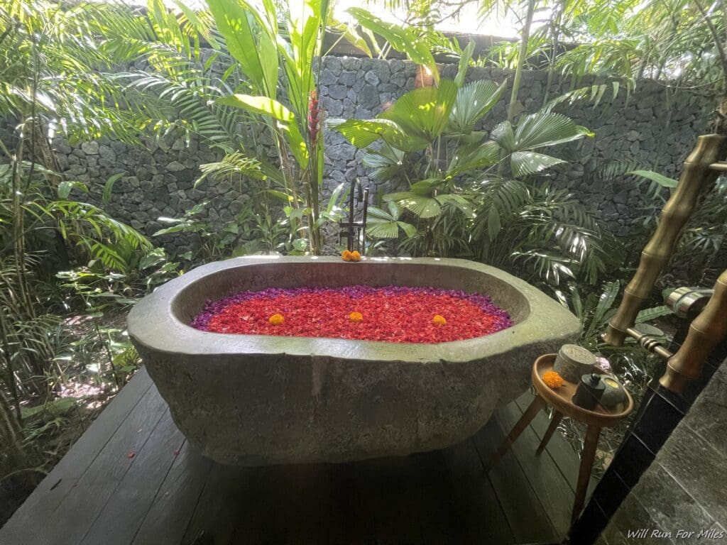 a stone bathtub with flowers in it