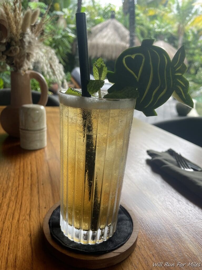 a glass with a drink and a straw