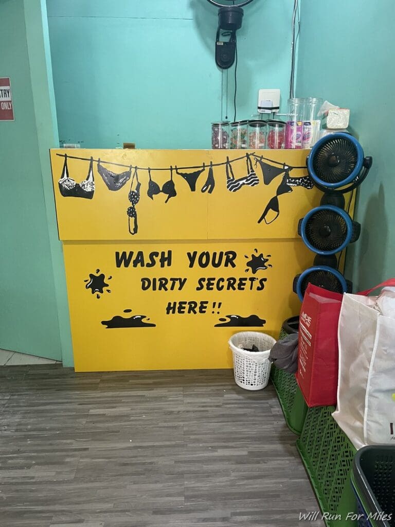 a yellow sign with black text and a laundry basket