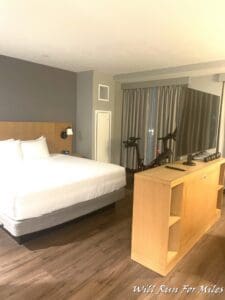 a room with a bed and a table and a mirror