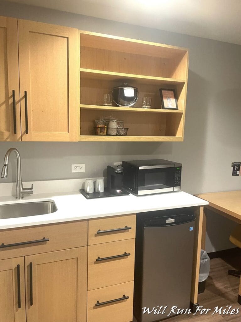 a kitchen with a microwave and a sink