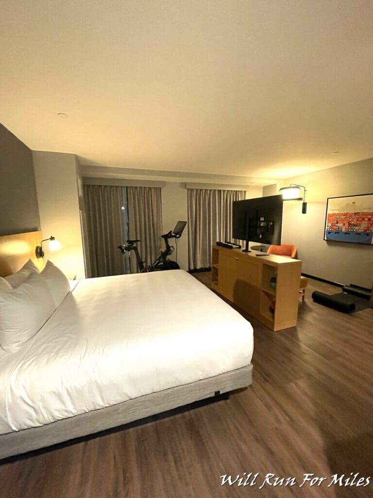 a room with a bed and a tv