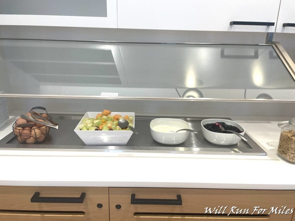 a bowl of fruit and yogurt on a counter