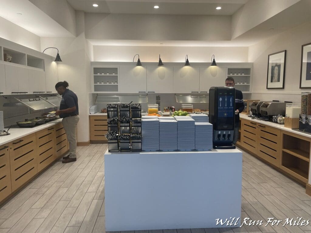 a man standing behind a counter in a kitchen