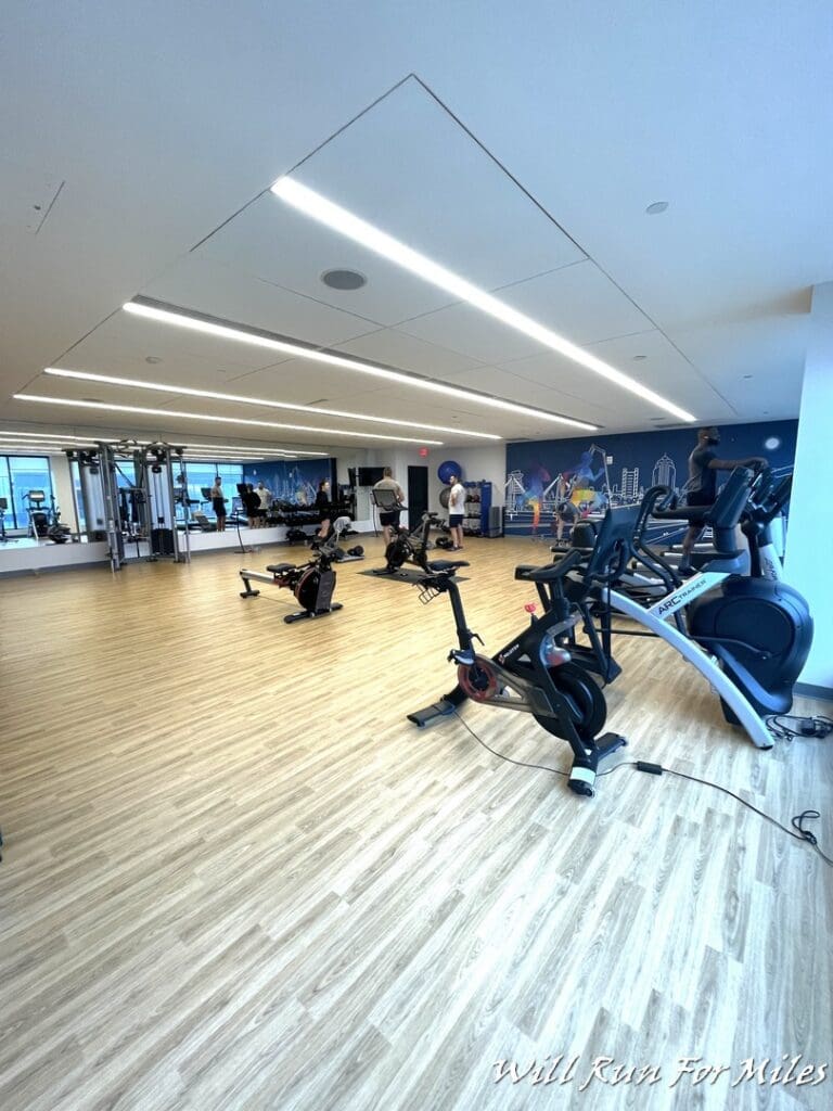 a room with exercise bikes and people in the background