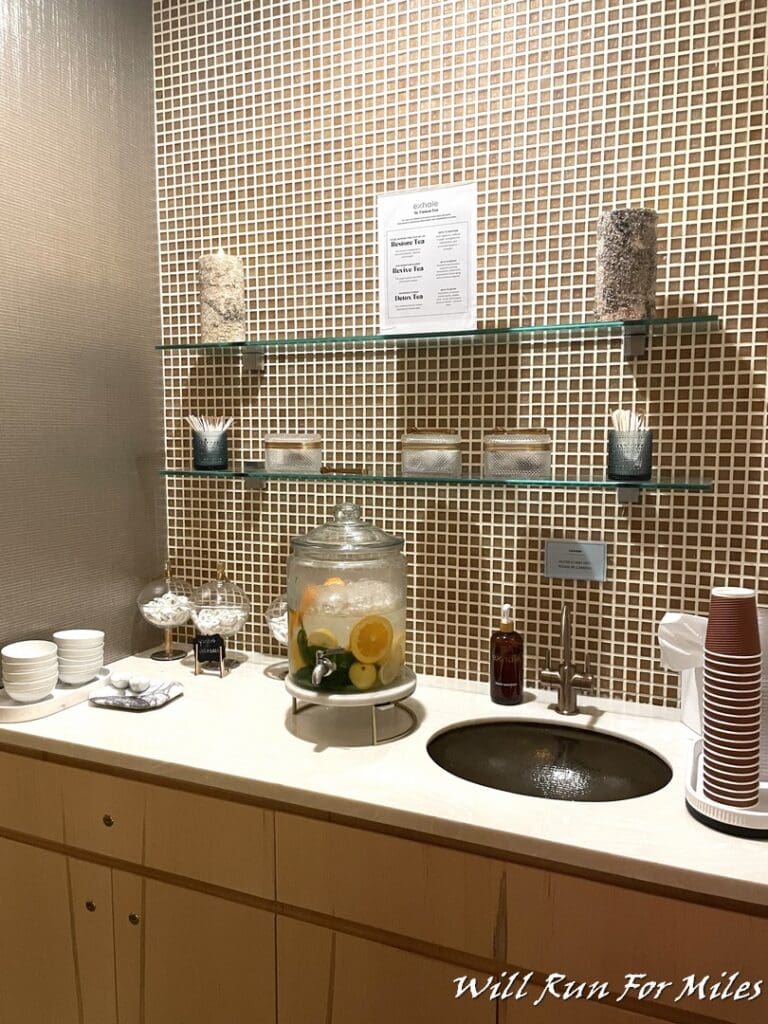 a counter with a glass jar and a sink