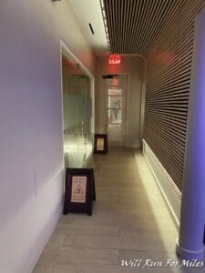 a hallway with a sign and a door