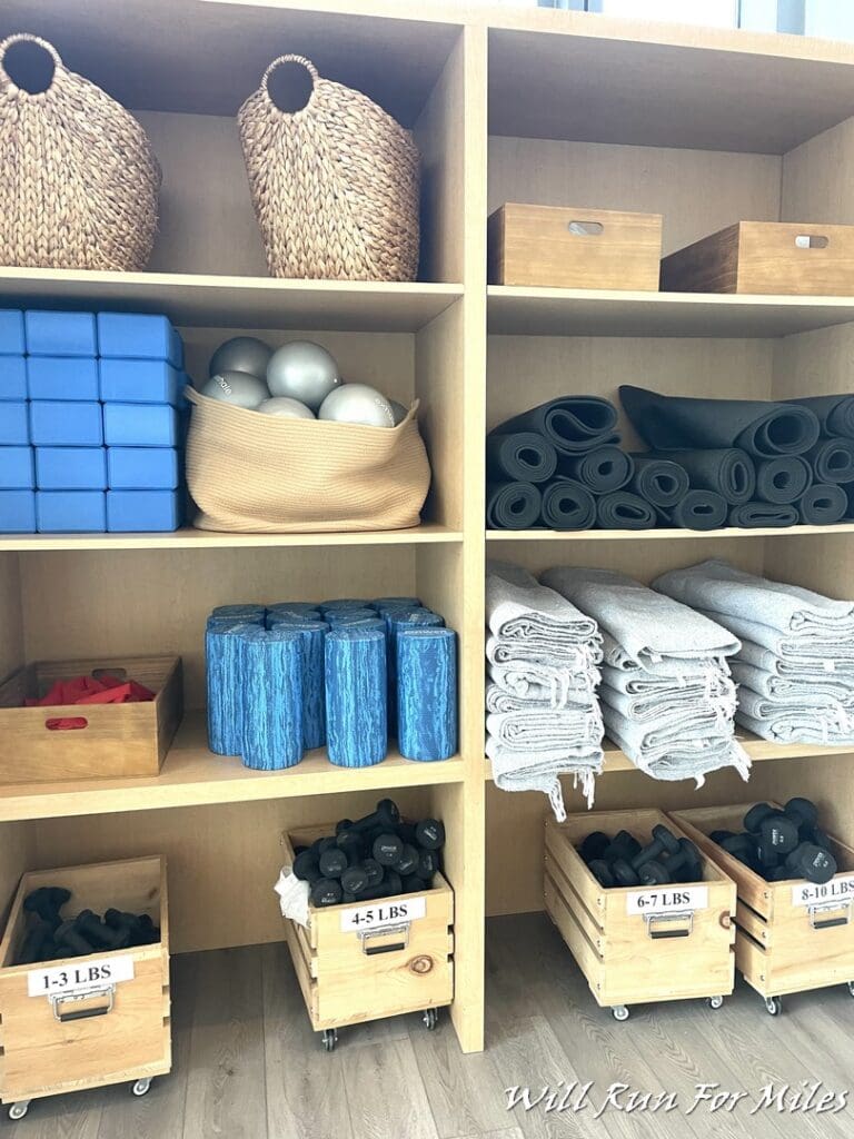 shelves with yoga mats and other items