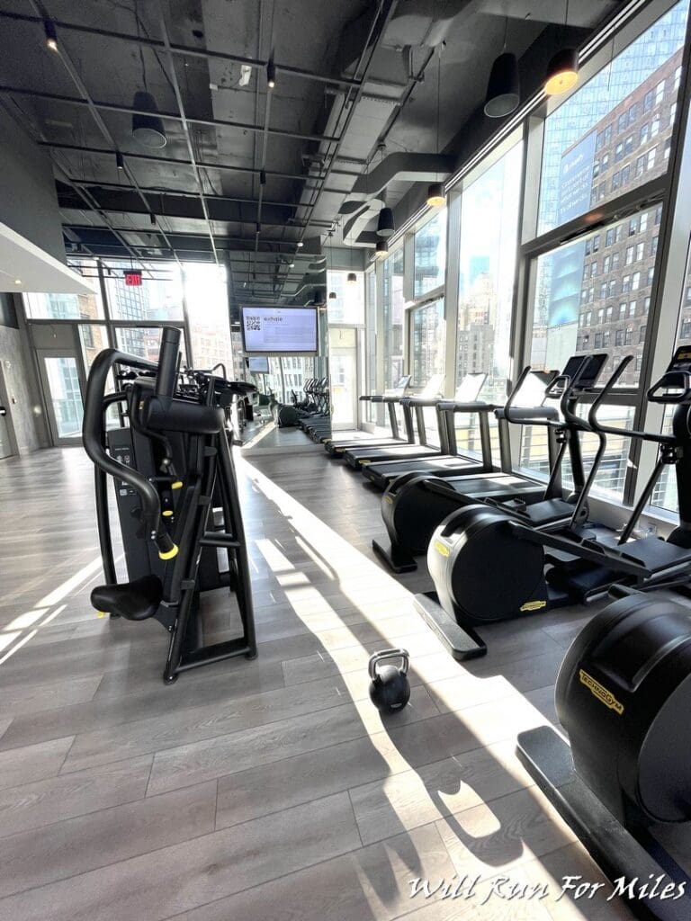 a room with exercise equipment and a large window