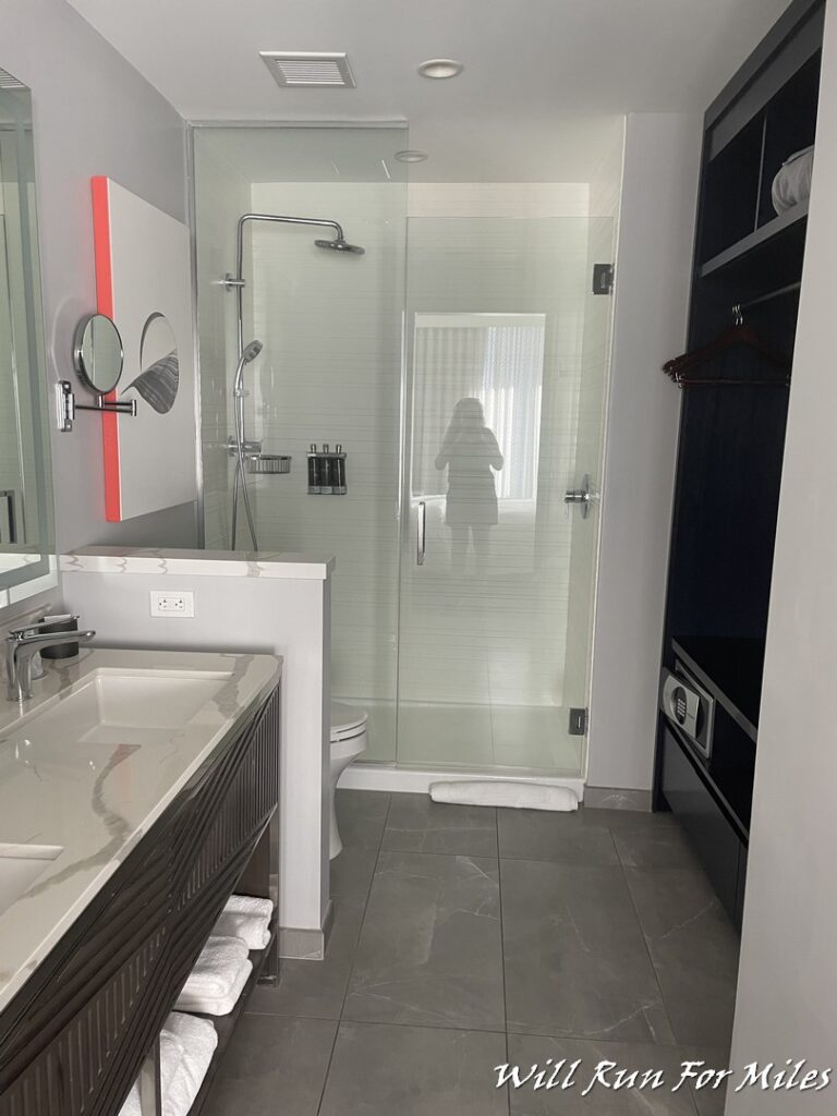 a bathroom with a glass shower door and sink