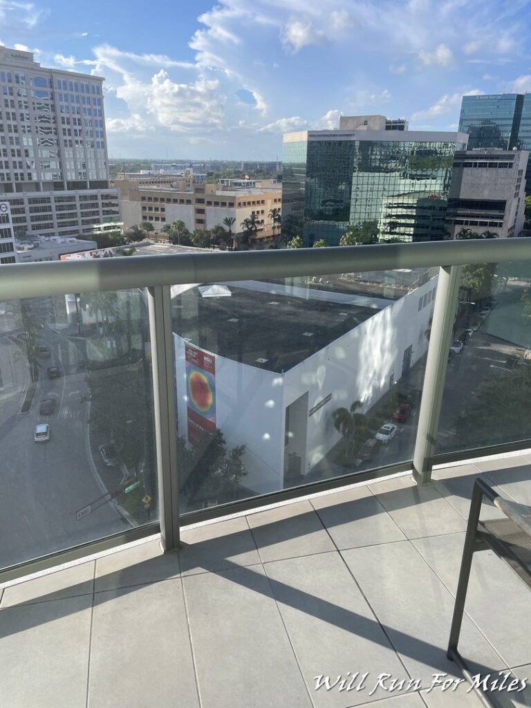 a balcony with a view of a city and a street