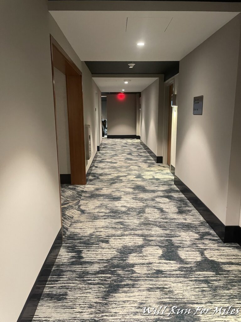 a hallway with a carpeted floor