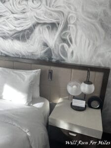 a bed with a lamp and a table