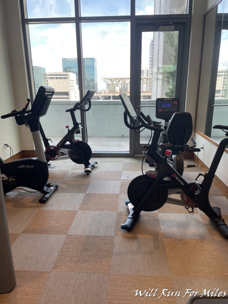 a room with exercise bikes and windows