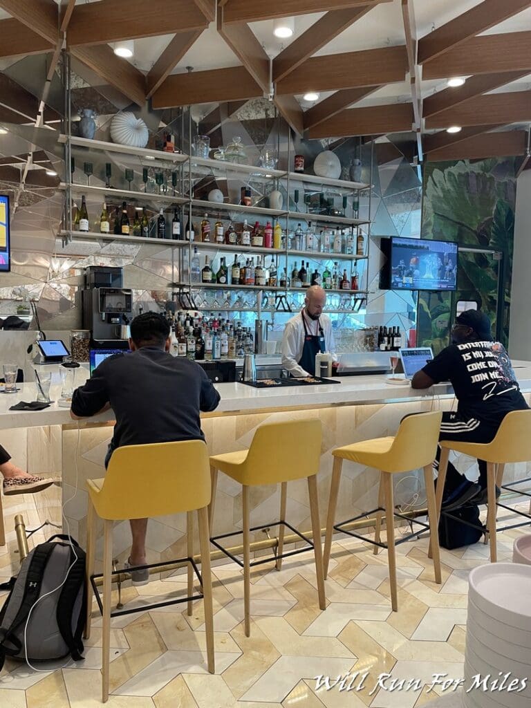 a group of people sitting at a bar