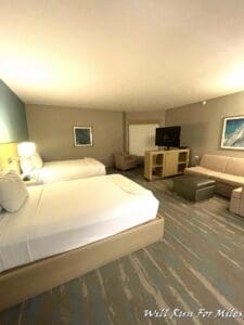 a room with two beds and a television