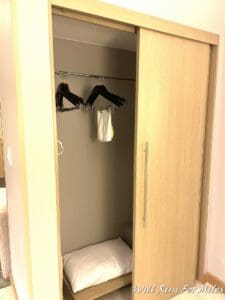 a closet with a bed and swingers