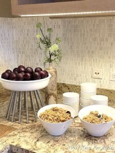 a bowl of fruit and cereal on a counter