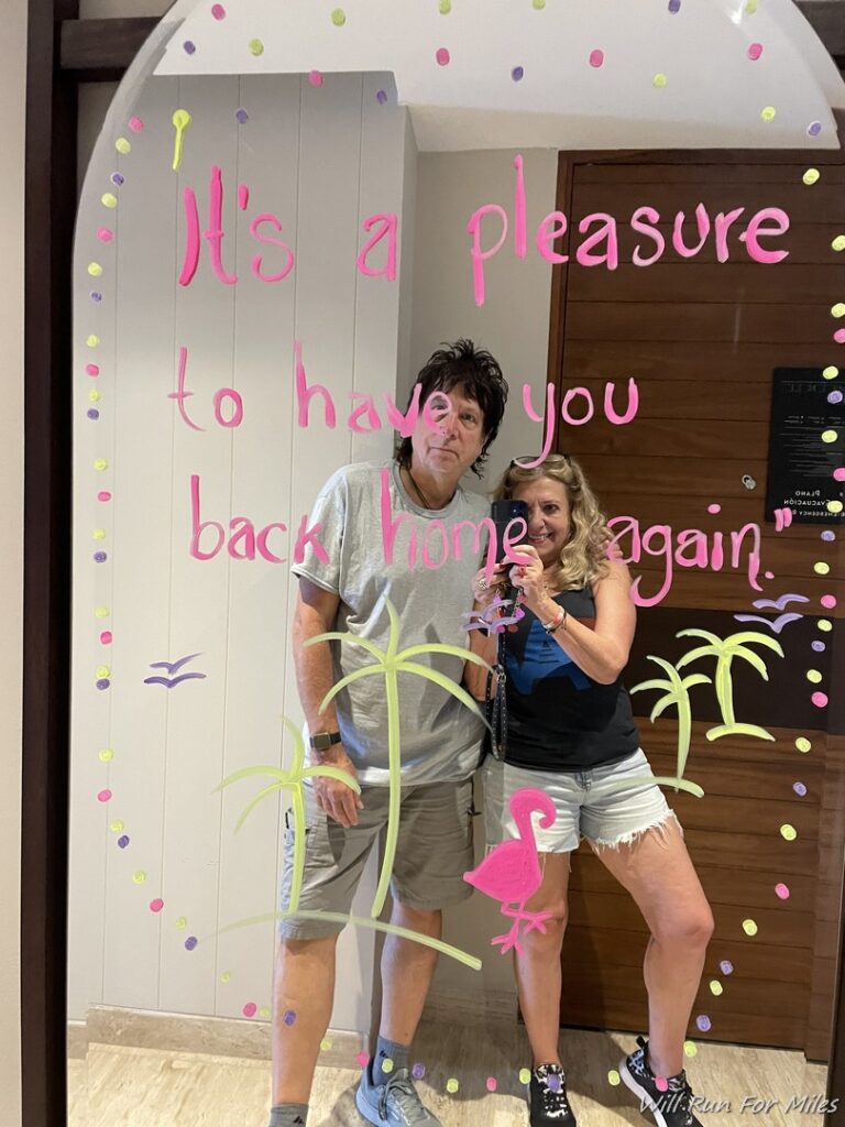 a man and woman standing in front of a mirror