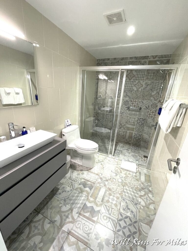 a bathroom with a shower and sink