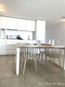 a kitchen with white cabinets and a table