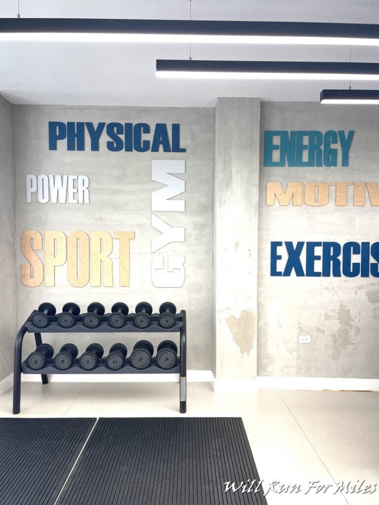 a room with dumbbells and a rack of weights