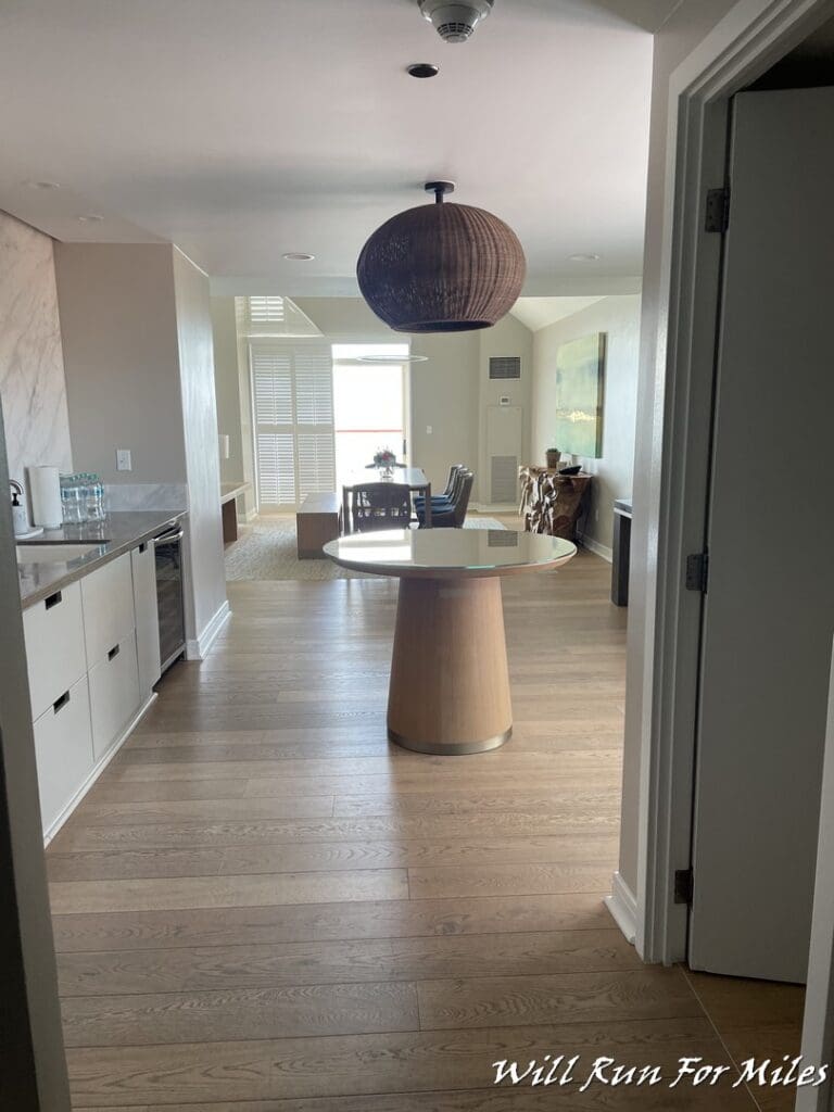 a dining room with a round table and a wood floor