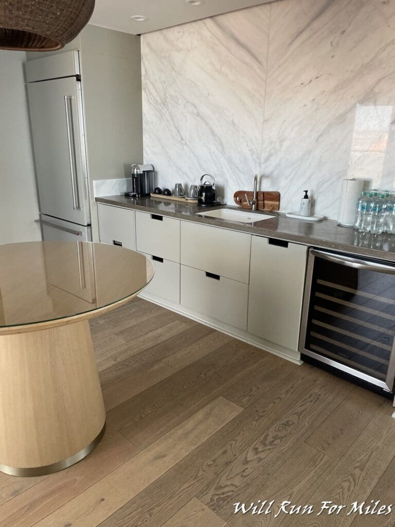 a kitchen with a table and a refrigerator