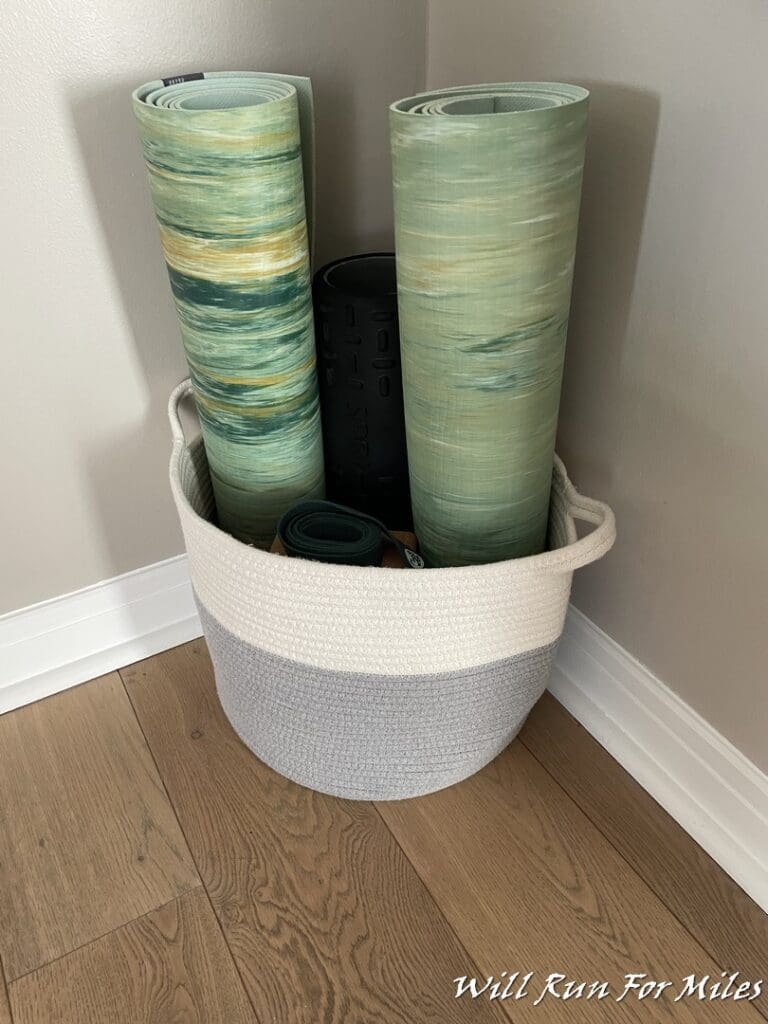 a basket with rolled up mats