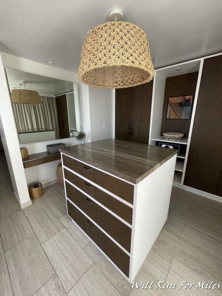 a room with a white counter and a brown cabinet