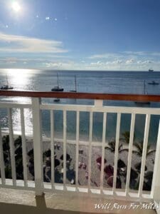 a balcony with a view of the ocean and boats