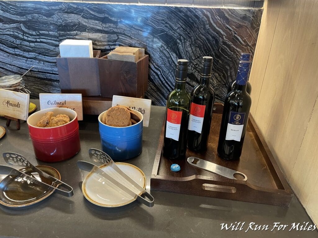 a table with bottles of wine and cookies