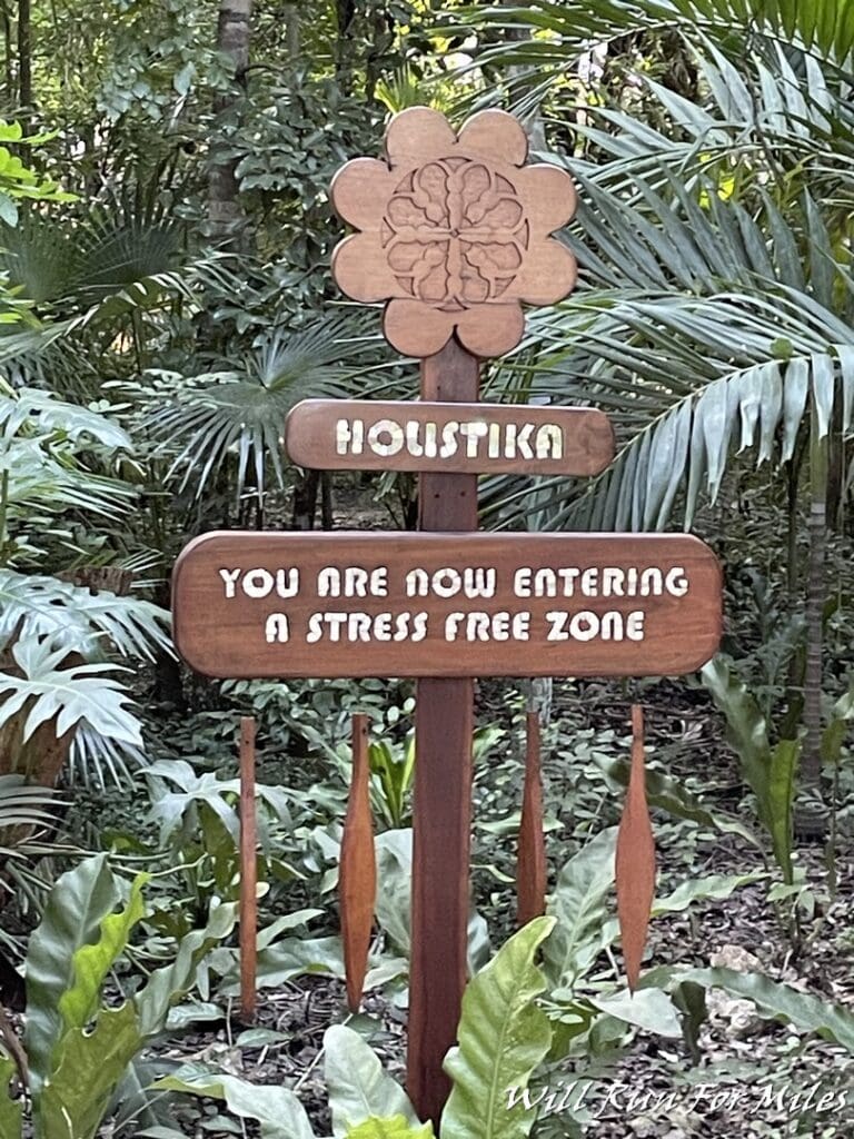 a sign in the middle of a forest