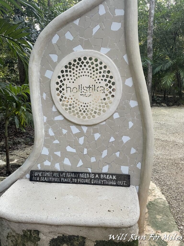 a stone bench with a sign on it