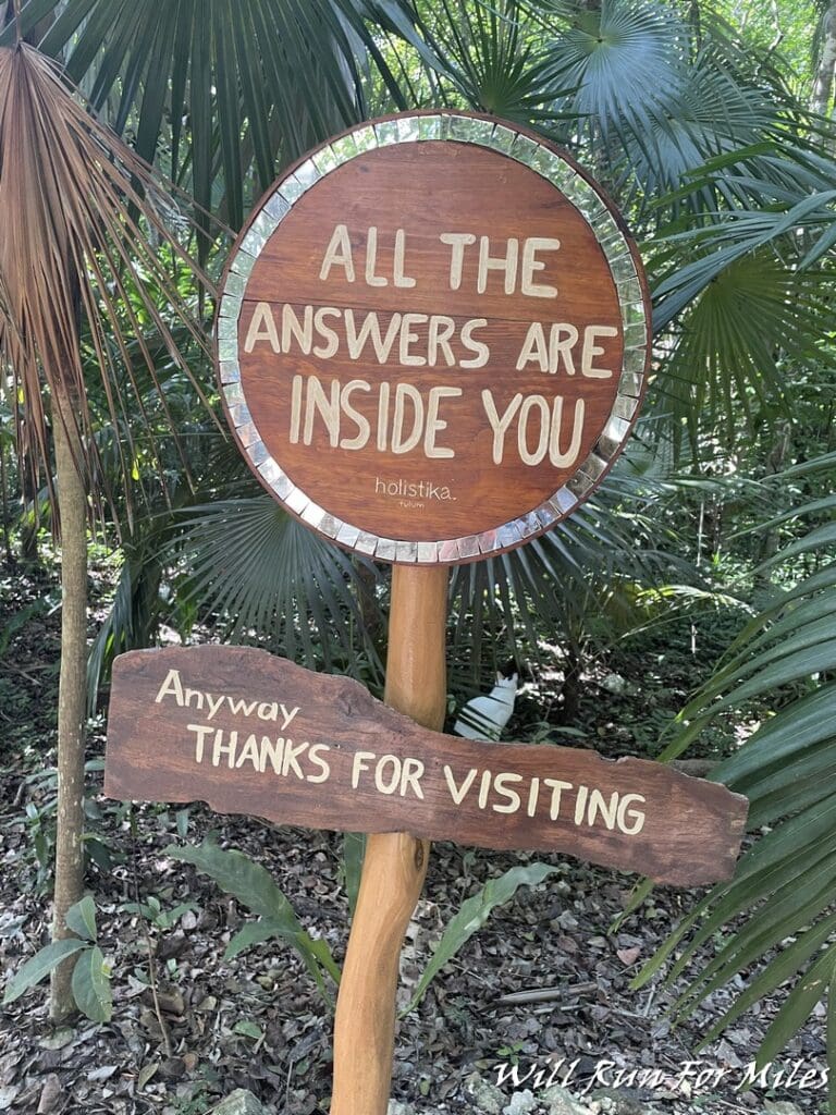 a sign in the middle of a forest