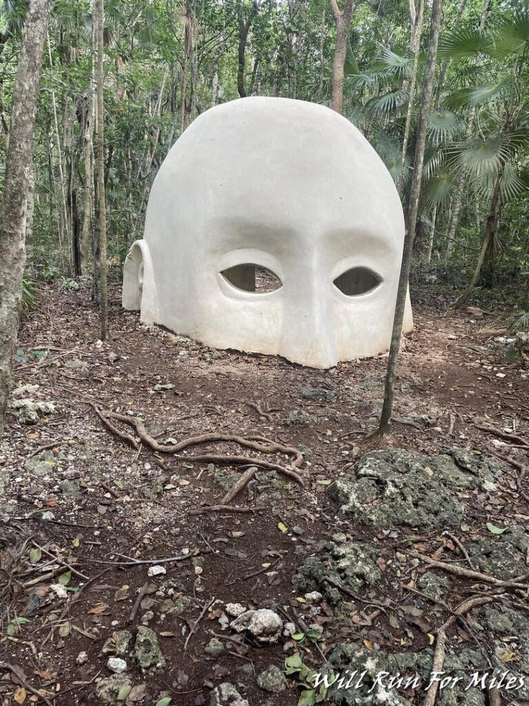 a white sculpture in the woods