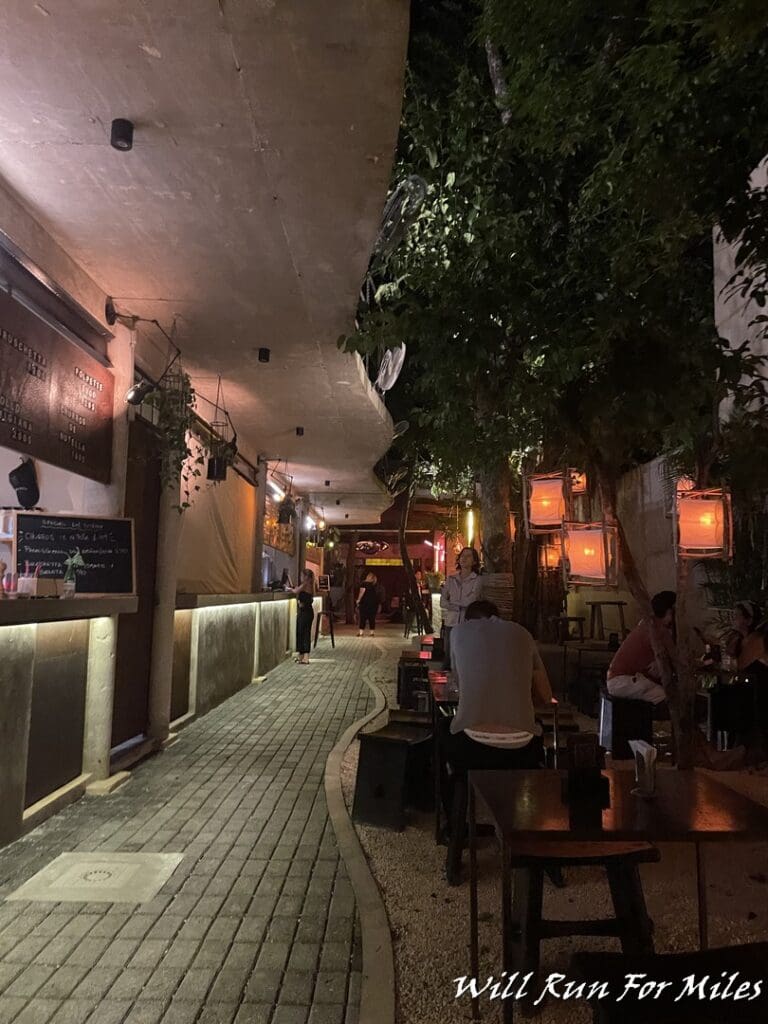 a walkway with tables and chairs