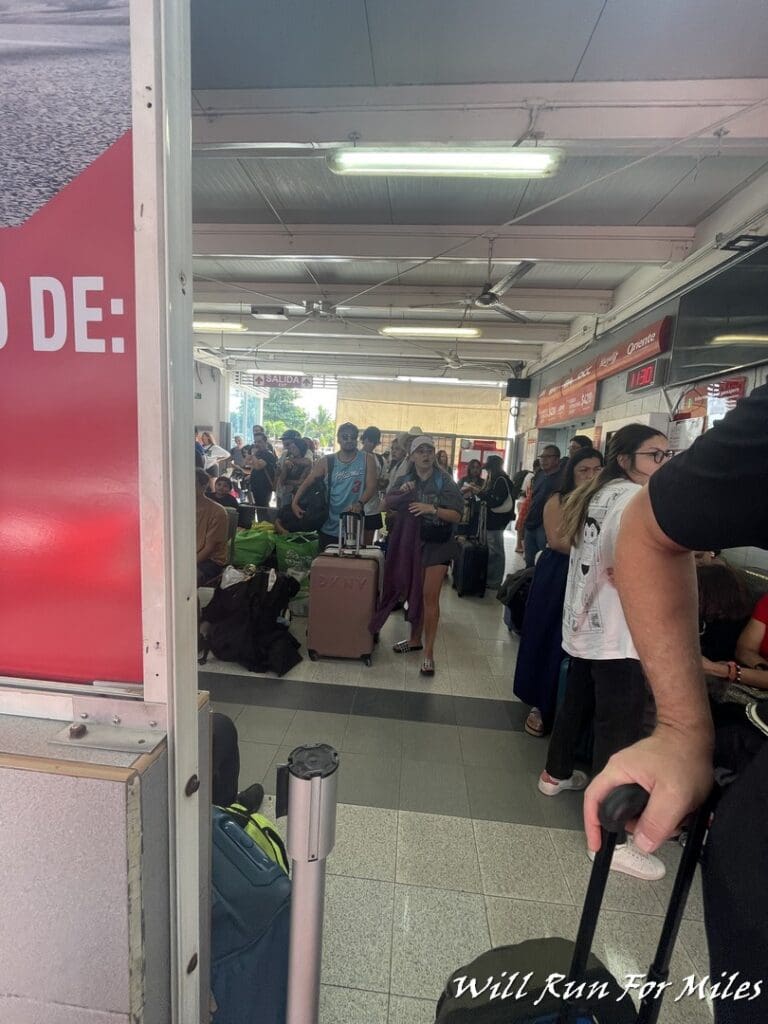 a group of people in a room with luggage