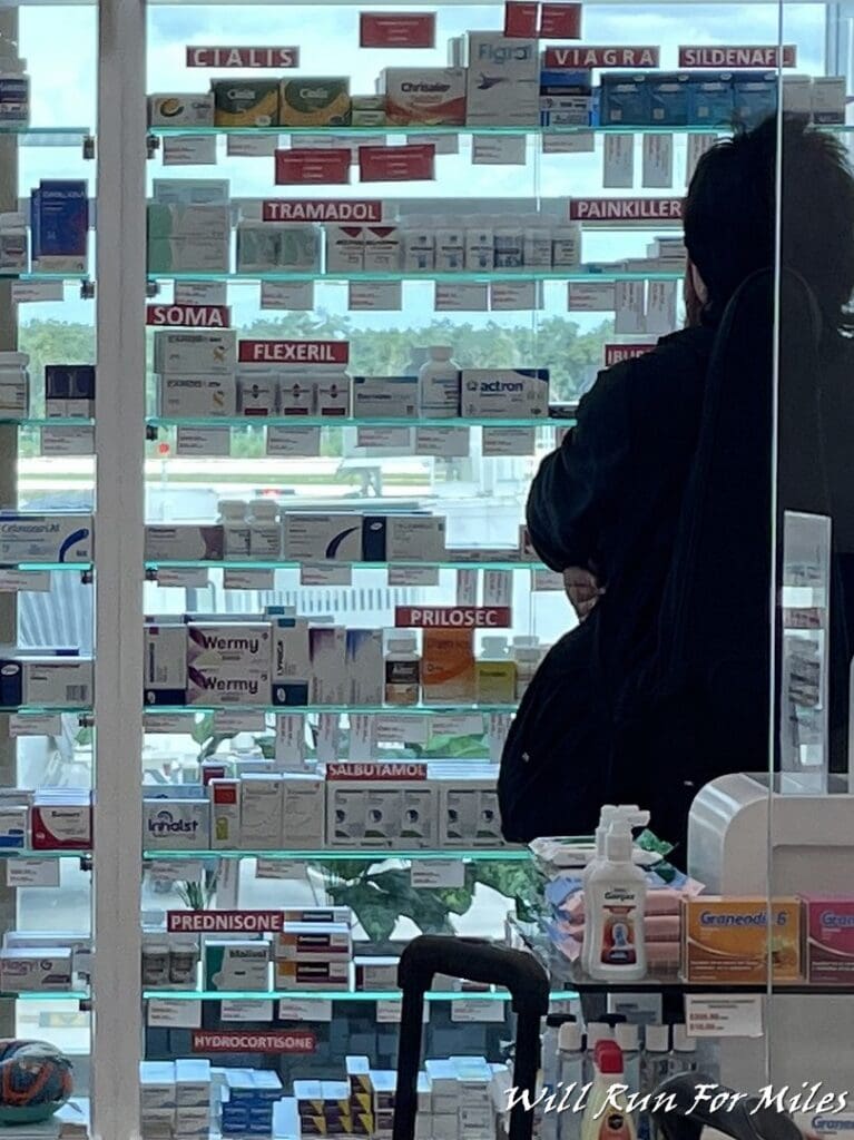 a woman looking at a shelf of medicine