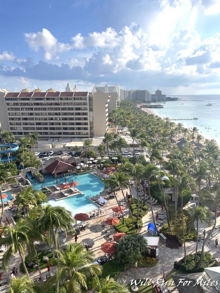 a resort with palm trees and a beach